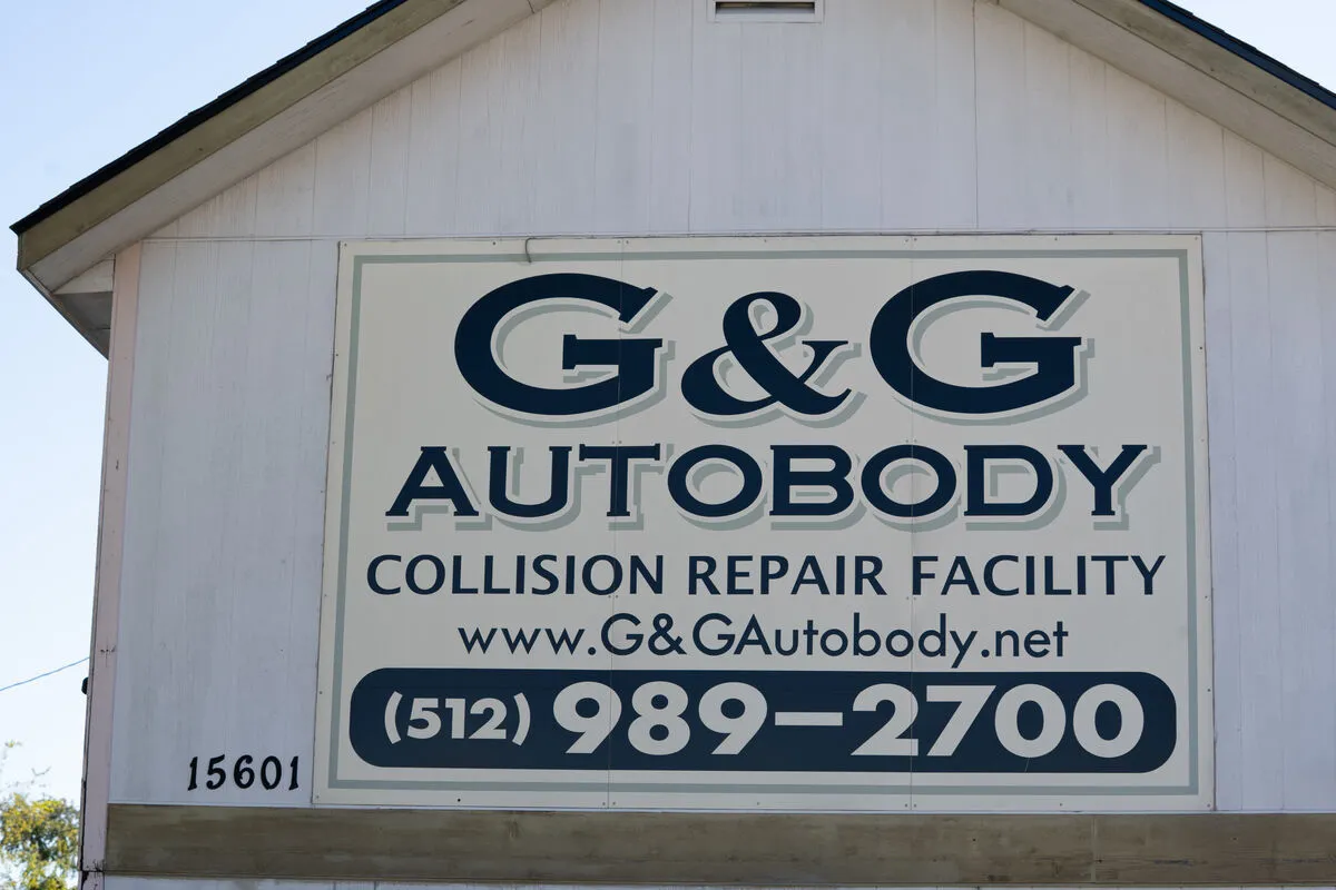 Expert auto body technician performing panel repair